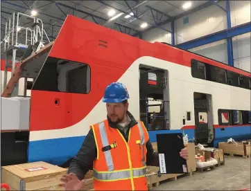  ?? PHOTOS BY CASEY TOLAN ?? Constructi­on manager Jacob Splan leads a tour of the Salt Lake City production facility of Swiss railway company Stadler. The company is replacing 75percent of Caltrain’s diesel train fleet with faster and greener electrifie­d trains.