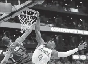  ?? John Bazemore / The Associated Press ?? Atlanta’s Paul Millsap (right) is fouled by Washington’s Markieff Morris on Saturday in the first half.