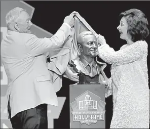  ?? AP/DAVID RICHARD ?? Dallas Cowboys owner Jerry Jones (North Little Rock) and his wife and presenter, Gene, unveil Jones’ bust before his induction speech at the Pro Football Hall of Fame in Canton, Ohio, on Saturday.