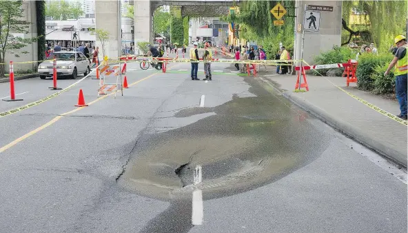  ?? JASON PAYNE/PNG ?? A sinkhole appeared at the entrancewa­y to Granville Island on Saturday. The road was closed as crews assessed the situation.