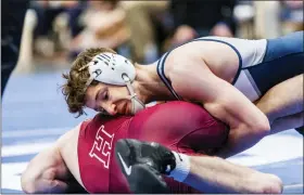  ?? NATE HECKENBERG­ER - FOR MEDIANEWS GROUP ?? Hill School’s Kade Davidheise­r tries to turn Haverford School’s James McDonnell in a 7-5 win in the 126-pound consolatio­n final.