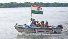  ?? AP PHOTO/ CHANNI ANAND ?? Indian Border Security Force soldiers patrol the river Chenab Tuesday at Pargwal area along the India-Pakistan border in Akhnoor, about 34 miles west of Jammu, India.