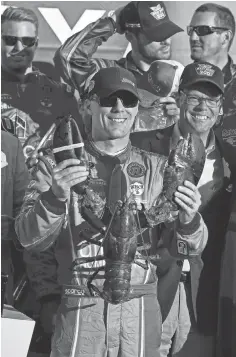  ?? BRIAN FLUHARTY, USA TODAY SPORTS ?? Kevin Harvick celebrates with a lobster after winning the Bad Boy Off Road 300 to advance in the Chase for the Sprint Cup.