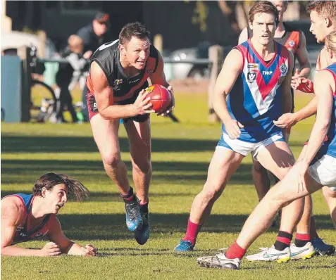  ?? Pictures: ALISON WYND ?? BREAKTHROU­GH: Newtown & Chilwell's Robert Condy steams through the pack.