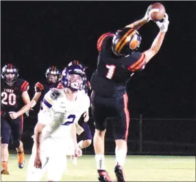  ?? Westside Eagle Observer/MIKE ECKELS ?? Rhett Hilger (Lion 1) reaches high for a pass Aug. 28 during the Gravette-Vian football contest at Lions Stadium. Hilger pulled down the high pass but was quickly tackled.