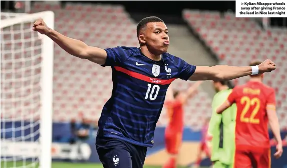  ??  ?? > Kylian Mbappe wheels away after giving France the lead in Nice last night