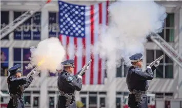  ?? ROBERTO E. ROSALES/JOURNAL ?? Members of the Albuquerqu­e Police Department Honor Guard fire a salute at Civic Plaza on Saturday afternoon to commemorat­e the first responders who lost their lives in the Sept. 11 attacks 20 years ago.