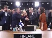  ?? Associated Press ?? Denmark Foreign Minister Lars Lokke Rasmussen, center left, shakes hands with Finland Foreign Minister Pekka Haavisto during a meeting at NATO headquarte­rs in Brussels on Tuesday.