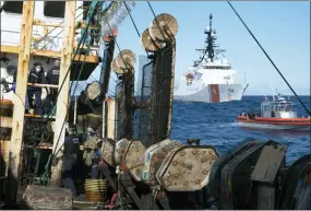  ?? PETTY OFFICER 3RD CLASS HUNTER SCHNABEL — U.S. COAST GUARD VIA AP ?? Guardsmen from the U.S. Coast Guard cutter James, seen at background right, conduct a boarding of a fishing vessel in the eastern Pacific Ocean in August. During the 10-day patrol for illegal, unreported or unregulate­d fishing, three vessels steamed away. Another turned aggressive­ly 90degrees toward the James, forcing the American vessel to maneuver to avoid being rammed.