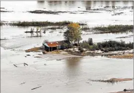  ??  ?? Flooding near Cairo is seen in November. The Len Small Levee was expanded in 1969 to span the bend in the river and “deflect high velocity floodwater­s” from agricultur­al land.