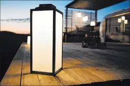  ?? Les Jardins Solar Lighting ?? The light reinterpre­ts the classic lantern design with a slim, teak-framed portable light that has a solar module producing LED light for up to 200 hours per charge. There’s a motion sensor and dimming capability as well.