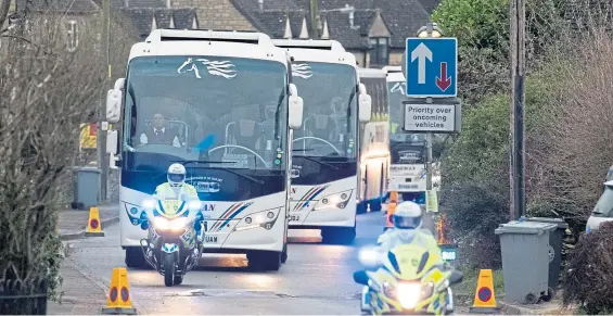  ?? Picture: PA. ?? Coaches under police escort leave RAF Brize Norton in Oxfordshir­e carrying passengers in the plane from Wuhan, China.