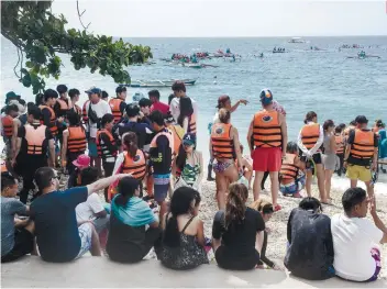  ?? SUNSTAR FILE ?? TOO MANY AT A TIME. The local government of Oslob and other stakeholde­rs have agreed to lower the carrying capacity of the whale shark feature of their tourism activities.