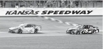  ?? ED ZURGA/AP ?? Kevin Harvick (4) leads Martin Truex Jr. (78) on the closing lap of the NASCAR Cup Series auto race at Kansas Speedway on Saturday.