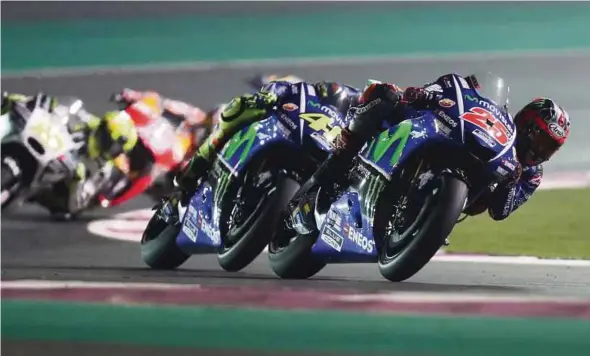  ?? AFP PIC ?? Maverick Vinales (right) and Valentino Rossi battling it out during the Qatar MotoGP in Doha on Sunday.