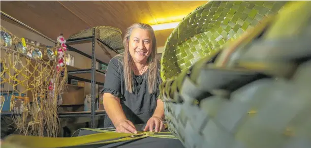  ?? Photo / Paul Taylor ?? Katarina May weaves harakeke wahakura from her Flaxmere garage turned studio.