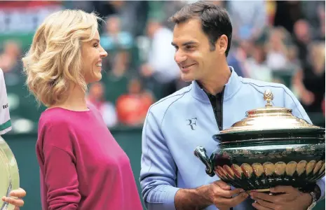  ?? Picture: EPA ?? MY NAME IS ROGER: Roger Federer of Switzerlan­d holds his trophy as he talks with Czech actress Eva Herzigova after defeating Alexander Zverev of Germany in the final of the ATP tournament in Halle on Sunday.