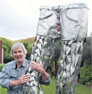  ?? PHOTO: TOM KITCHIN ?? Giant strides . . . Alexandra artist Olaf Mengeringh­ausen with his sculpture ReLax, which is on display at the Stationsid­e Cafe in Lauder for the Arts on the Rail Trail programme.