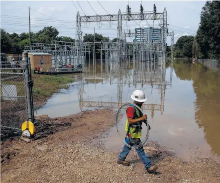  ?? Michael Ciaglo photos / Houston Chronicle ?? CenterPoin­t Energy is working to restore power to those who get their electricit­y from a flooded substation on the west side.