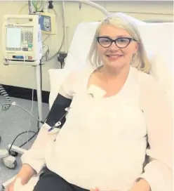  ??  ?? Melanie Kennedy smiles from her hospital bed after treatment