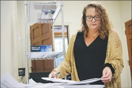  ?? HANNAH SCHOENBAUM / AP ?? Wayne County Elections Director Anne Risku prepares absentee ballots Sept. 23 at the Wayne County board of elections office in Goldsboro, N.C. Risku said there were issues with poll watchers from both parties during a primary election in May. But of the 13 incidents she reported to the North Carolina board from Wayne County, all involved Republican­s.