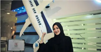  ??  ?? Dalia Yashar, one of the first Saudi students who registered to become a commercial pilot, stands in front of the registrati­on center, CAE Oxford ATC, where Saudi women can pursue a carrier as a commercial pilot, at King Fahd Internatio­nal Airport in...