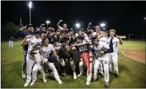  ?? DOUGLAS ZIMMERMAN — SPECIAL TO THE MARIN INDEPENDEN­T JOURNAL ?? Brad Burnes (28) of Marin Catholic holds the championsh­ip banner and poses with his teammates after hitting the game winning home run against Redwood in the MCAL baseball championsh­ip game at Albert Park in San Rafael.