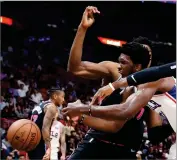  ?? AP PHOTO BY BRYNN ANDERSON ?? Philadelph­ia 76ers center Joel Embiid goes for the ball against the Miami Heat in the first quarter of an NBA basketball game Monday, Nov. 12, in Miami.