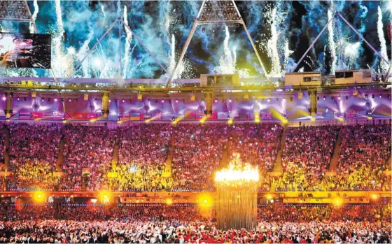  ?? (AFP FOTO) ?? EXTRAVAGAN­ZA. Fireworks light up all over the Olympic Stadium after seven young athletes light the Olympic Cauldron in the opening of the 2012 London Olympics.