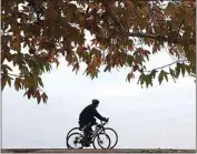  ?? ALEX HORVATH / THE CALIFORNIA­N ?? Cyclists ride east along the Kern River Parkway, where changes may be coming.