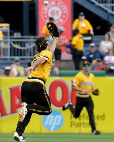  ?? Matt Freed/ Post- Gazette ?? Pirates second baseman Adam Frazier can’t get to a bloop single by the Mets’ J. D. Davis in Sunday’s game at PNC Park. The 13- 2 defeat was among the 21 of 25 the Pirates have lost since the break.