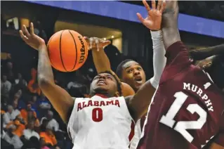  ?? AP PHOTO/JOHN AMIS ?? Mississipp­i State guard Shawn Jones Jr., rear, blocks a shot by Alabama’s Jaden Bradley (0) during the second half of an SEC tournament quarterfin­al Friday in Nashville. Alabama won 72-49 to advance to Saturday’s semifinals and will face Missouri, which beat Tennessee.