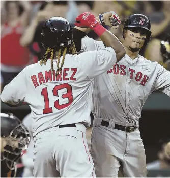  ?? AP PHOTO ?? TWO GOOD: Hanley Ramirez, left, and Xander Bogaerts celebrate Ramirez’ two-run fifth-inning home run against the Orioles last night in Baltimore.