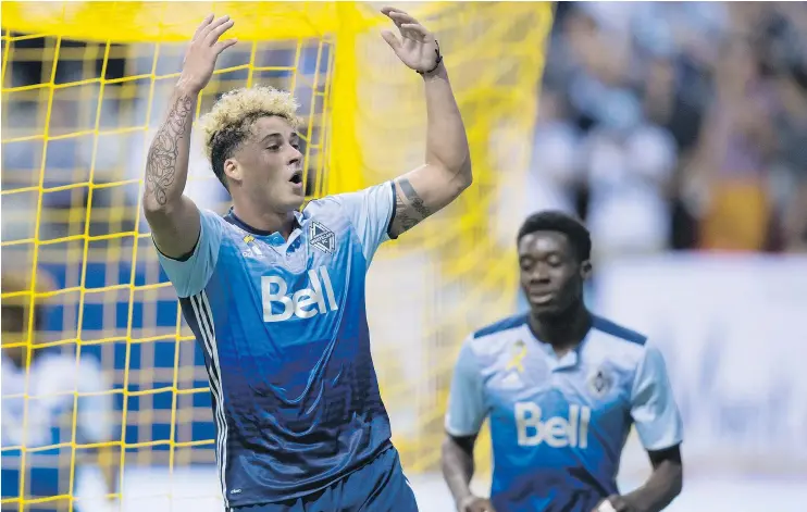  ?? THE CANADIAN PRESS ?? The Whitecaps’ Erik Hurtado, front, celebrates his goal against Minnesota United as Alphonso Davies comes to join him in Vancouver on Wednesday.