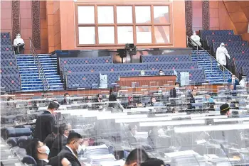  ??  ?? The three MPs entering the Dewan Rakyat in PPE. - Bernama photo