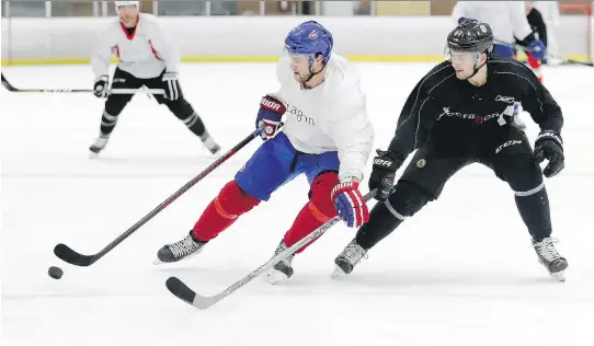  ?? JOHN MAHONEY ?? Montreal’s Jonathan Drouin holds off Jakub Zboril of the Boston Bruins during a scrimmage on Monday at Lower Canada College.