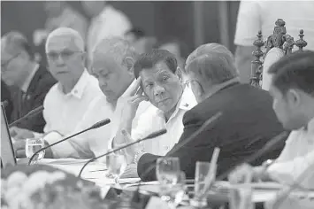  ?? PRESIDENTI­AL PHOTO/PHILSTAR.COM ?? President Rodrigo Roa Duterte greets Trade and Industry Secretary Ramon Lopez prior to the start of the 19th Cabinet Meeting in Malacañan Palace on October 4.