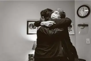  ?? Erin Schaff / New York Times ?? Bridget Ryan, left, a member of the peer support program at Christiana Hospital in Newark, Del., shares a social distance-defying hug with nurse Christina Burke after a counseling session.