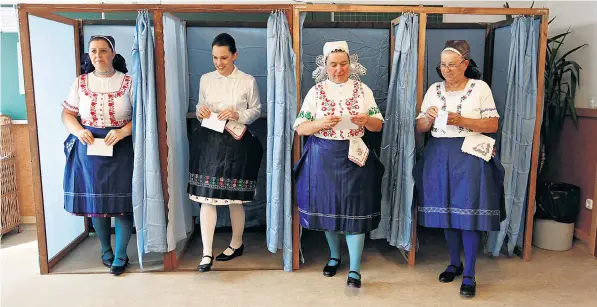  ??  ?? Hungarian women in traditiona­l costume leave a voting booth at a polling station after voting on EU migrant quotas. The referendum was the brainchild of Viktor Orban, who said it was a defence of Hungarian sovereignt­y