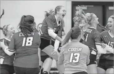  ?? Jeremy Stewart / Rome News-Tribune ?? Coosa’s Jordan Roberts (5) leaps into the air as she celebrates with her teammates after winning Wednesday’s match.