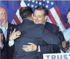  ?? SCOTT OLSON, GETTY IMAGES ?? Sen. Ted Cruz gets a hug from Wisconsin Gov. Scott Walker during a celebratio­n in Milwaukee after polls closed Tuesday.