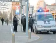  ?? AFP ?? Police keep watch on a road in Beijing on Tuesday.