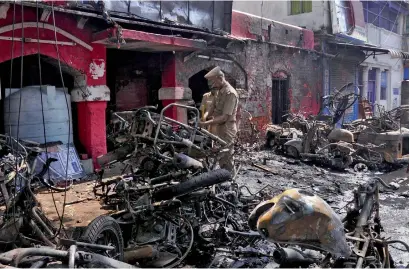  ?? Reuters ?? Policemen inspect charred remains of the Ice House police station which was set on fire by the demonstrat­ors during a protest demanding a permanent solution to ensure the unhindered conduct of Jallikattu in Chennai on Monday. —