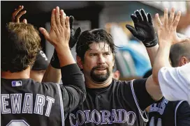  ?? AP FILE ?? Todd Helton played 17 seasons with the Rockies and hit .316 for his career, including a National League-leading .372 in 2000. But voters could hold the thin air of Denver and the offensive emphasis of the game during his career against him.