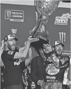  ?? JASEN VINLOVE/USA TODAY SPORTS ?? Martin Truex Jr. celebrates with crew chief Cole Pearn, left, after earning the Monster Energy NASCAR Cup Series title.