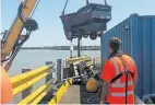  ?? PHOTO: PLA ?? Unloading skips of stationery and cleaning products from KM Otter at Woods Quay.