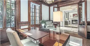  ?? ALEX ROTHE PHOTOS ?? Double French doors open to the main-floor library with heated hardwood flooring, wall panelling with sound absorption, a coffered ceiling and built-in bookcases.