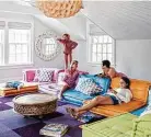  ??  ?? An oversized Roche Bobois sectional sofa instantly makes this media room fun, colorful and comfortabl­e. It’s also easy to reconfigur­e.