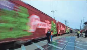  ?? MIKE DE SISTI / MILWAUKEE JOURNAL SENTINEL ?? The Canadian Pacific Holiday Train rolls along before stopping. Several more stops are scheduled for Monday, including Portage, Wisconsin Dells and La Crosse.