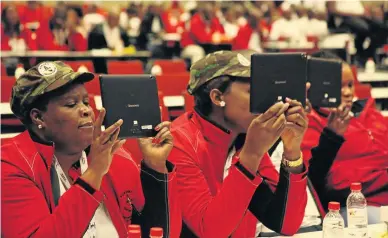  ?? PHOTO: CAIPHUS MAKHURA ?? DISTRACTIN­G FREEBIE: Popcru delegates enjoy setting up their tablets during their national congress in Durban yesterday